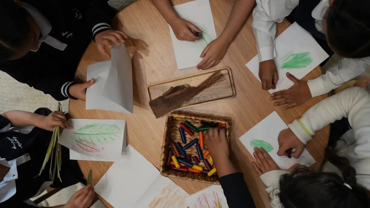 3 - Times of Dubai Children sitting around a round table and drawing leaf sketches with crayons