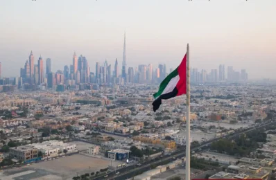 Uae flag flying over dubai skyline times of dubai