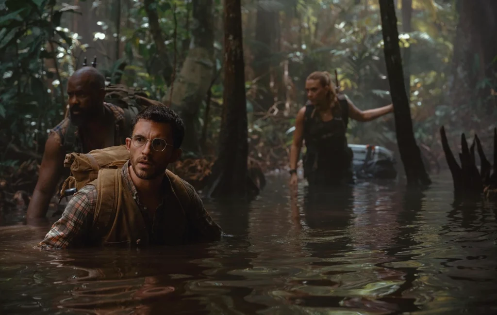 Jonathan Bailey Scarlett Johansson and Bechir Sylvain cross a river in Jurassic World Rebirth Times of Dubai