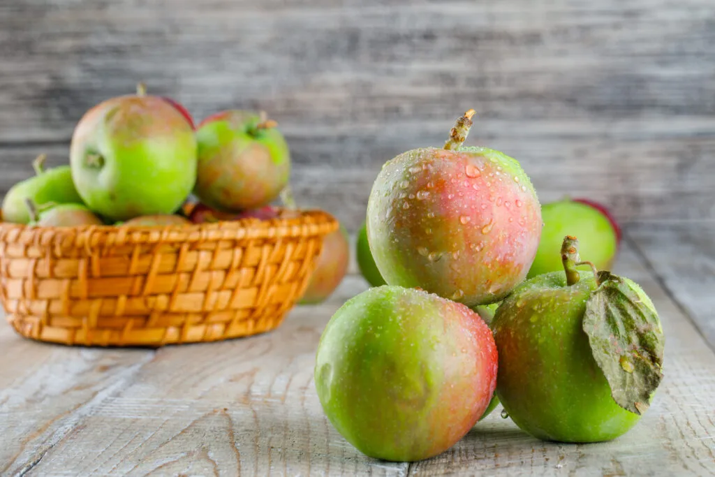Chilly apples in a wicker basket on a wooden background. side view. - Times of Dubai Indian garhwali apples in dubai a mountain delight reaches royal tables times of dubai