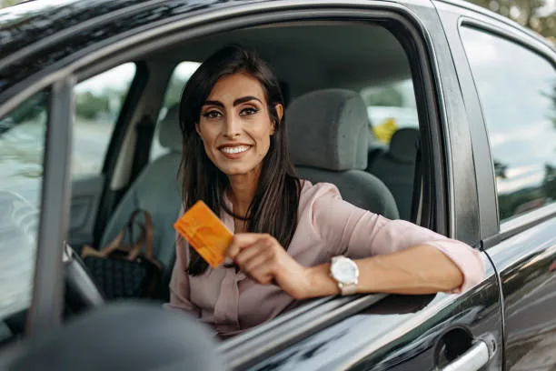 Portrait of a woman going to office in her car. Holds credit card - Times of Dubai Parking passes for uae students step by step guide to getting your permit times of dubai