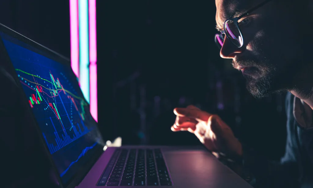 A man analyzing stock market charts, financial data on an electronic board. - Times of Dubai India stock market ranking slips from asias no 1 to least favoured amid tariff tensions times of dubai