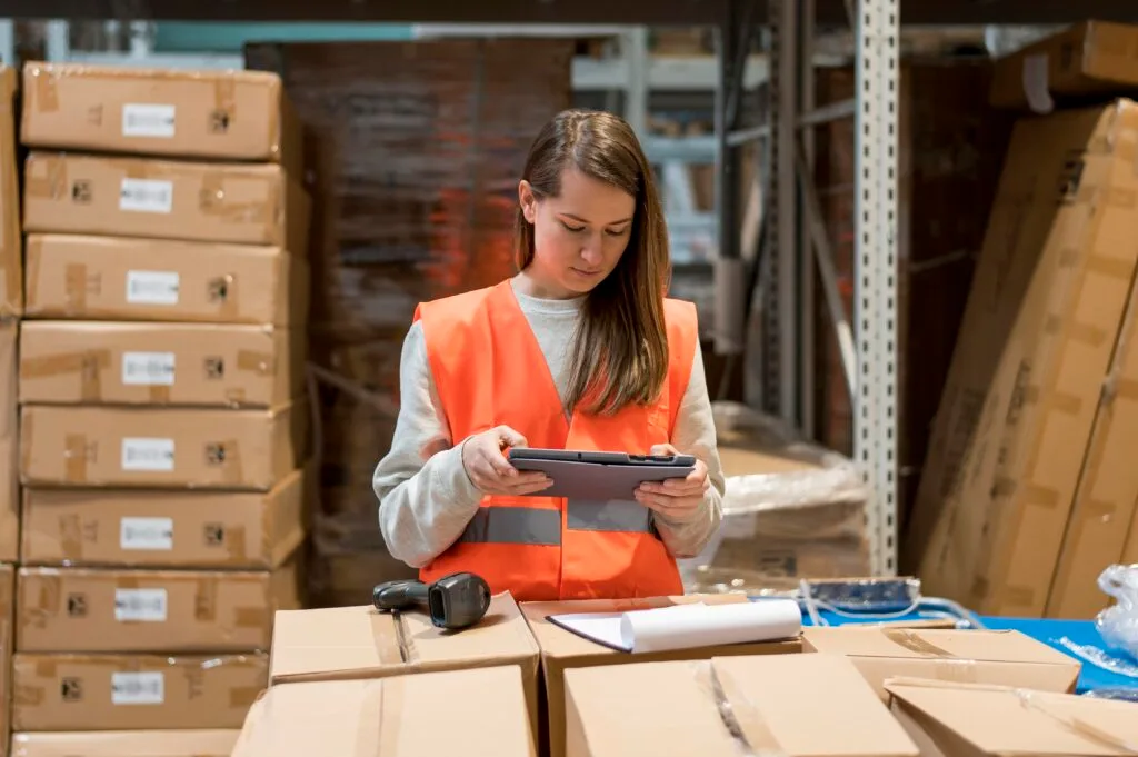 medium-shot-woman-with-tablet - Times of Dubai Us tariff on small packages times of dubai