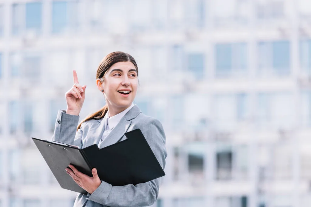modern-businesswoman-with-clipboard-outdoors - Times of Dubai Uae probation rule sets 6 month limit yet extended evaluations rise times of dubai