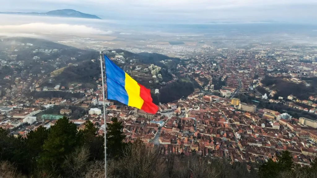national-flag-top-hill-near-barsov-bare-trees-low-clouds-cityscape-romania_1268-19608 - Times of Dubai Romania times of dubai