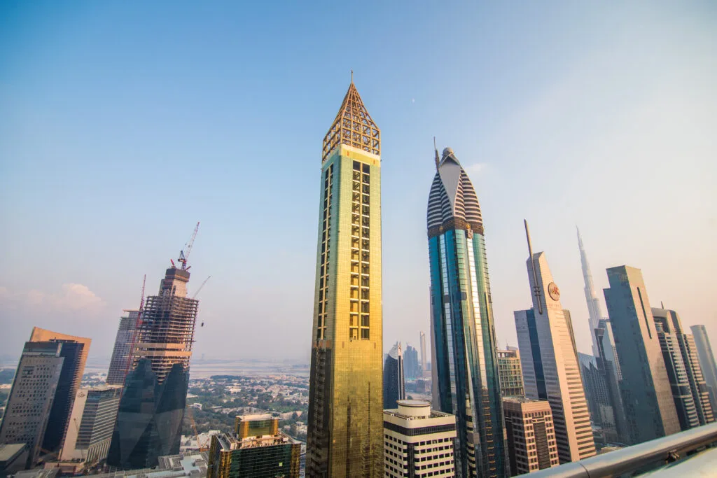 Scenic aerial view on downtown Dubai, United Arab Emirates with skyscrapers and highways. Colourful travel background. - Times of Dubai Indian investment rules in uae property why credit cards wont work for down payments times of dubai