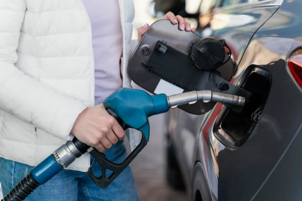 woman-filling-up-car-gas-station - Times of Dubai Uae petrol prices september will rates drop Times of dubai