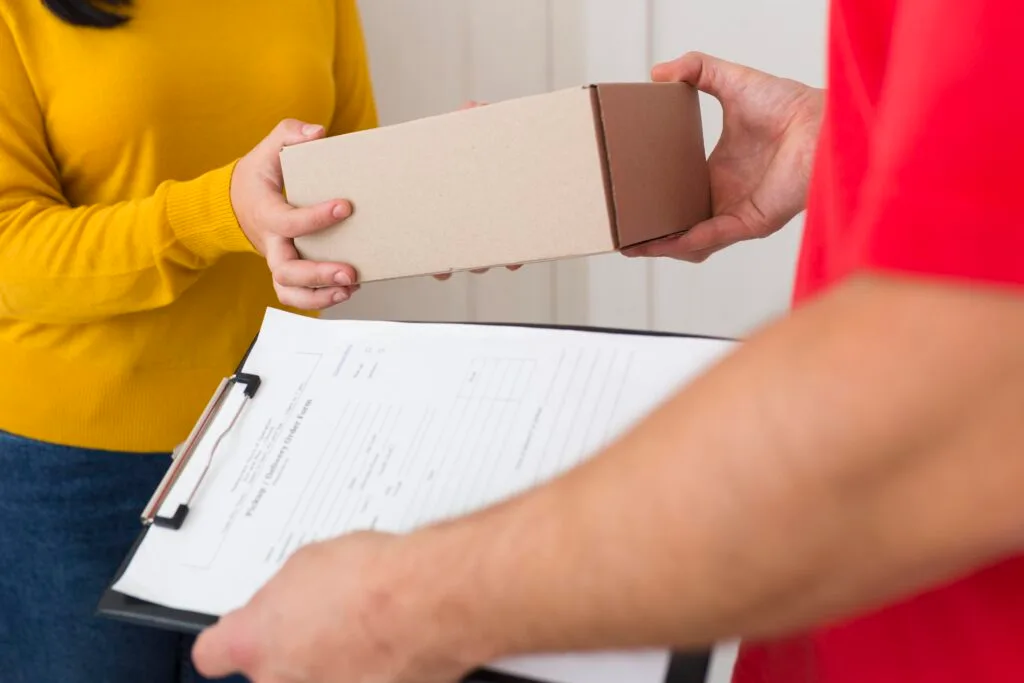 woman-receiving-her-new-cyber-monday-purchase-close-up - Times of Dubai Us tariff on small packages times of dubai