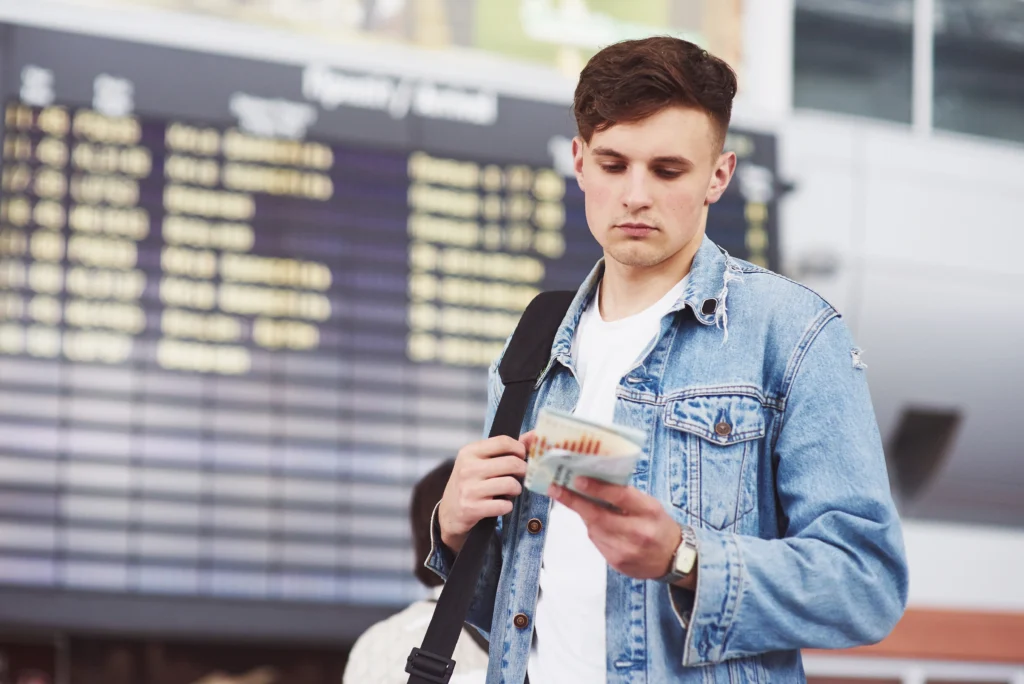 young handsome man with bag his shoulder hurry airport Times of Dubai